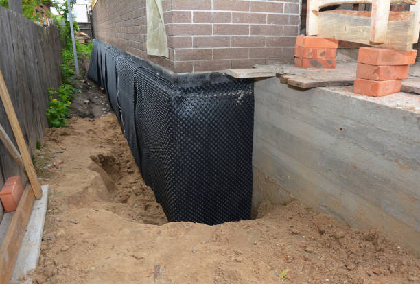 SJ Waterproofing Pros technician performing targeted Wet Basement Repair assessment in Leipsic, OH